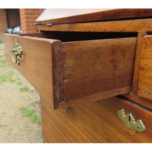 785 - A George III mahogany and oak bureau, the fall front enclosing an array of small drawers and cubby h... 