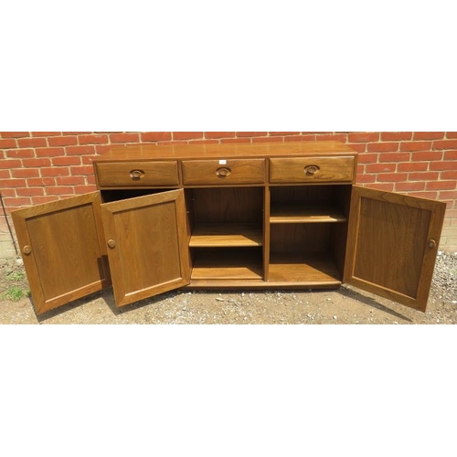 786 - An Ercol Windsor solid elm 'Golden Dawn' sideboard with three single drawers over three cupboards, a... 