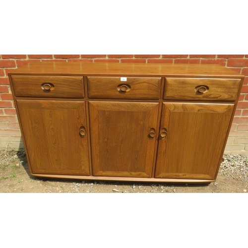 786 - An Ercol Windsor solid elm 'Golden Dawn' sideboard with three single drawers over three cupboards, a... 