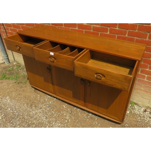 786 - An Ercol Windsor solid elm 'Golden Dawn' sideboard with three single drawers over three cupboards, a... 