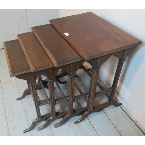 787 - An Edwardian mahogany quartet of nesting tables raised on reed supports with openwork lattice side s... 