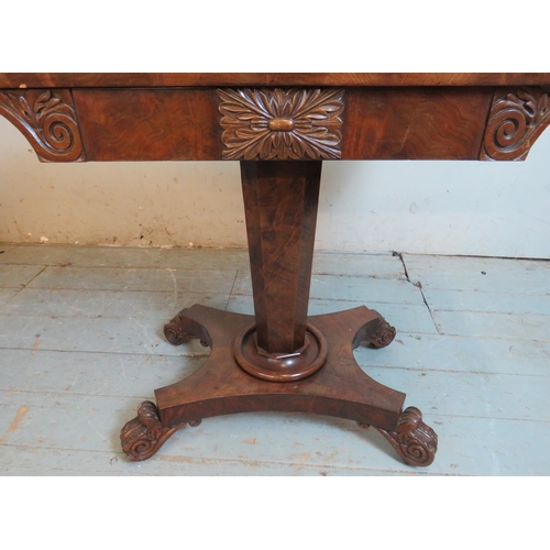 788 - A Victorian mahogany turn over card table with carved & scrolled frieze, raised on a tapering octago... 