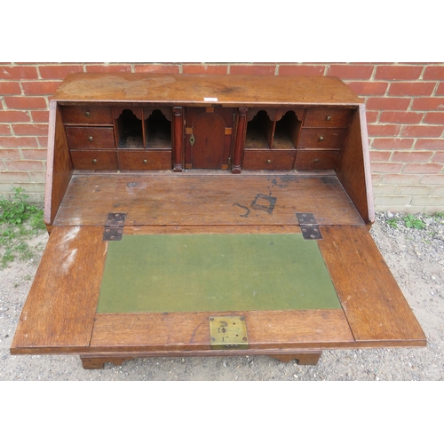 793 - A Georgian oak bureau, the fall front enclosing a fitted interior with document safe & secret drawer... 