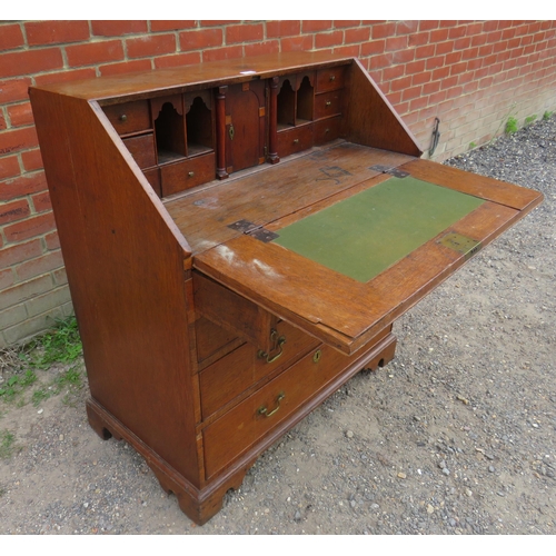 793 - A Georgian oak bureau, the fall front enclosing a fitted interior with document safe & secret drawer... 