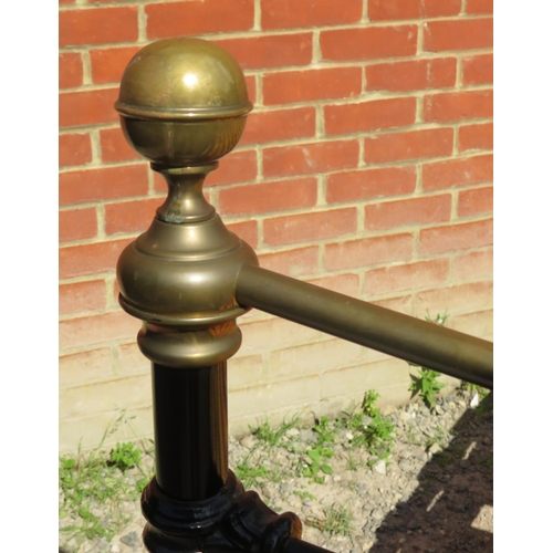 798 - A Victorian wrought iron brass double bed painted black with brass ball finials. Complete with mattr... 