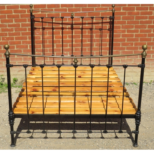 798 - A Victorian wrought iron brass double bed painted black with brass ball finials. Complete with mattr... 