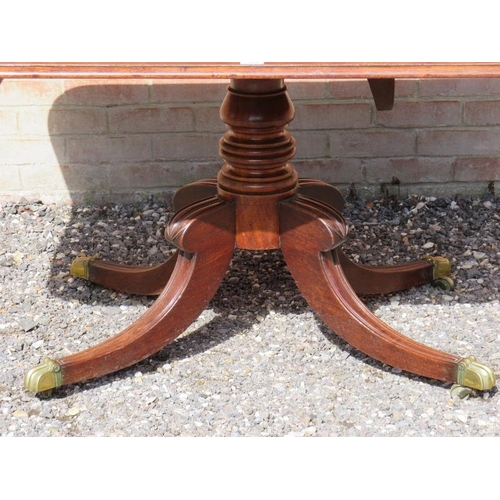 810 - A Regency mahogany rectangular tilt top breakfast table, with a turned pedestal raised on four sabre... 