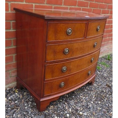 814 - A small reproduction Georgian style walnut veneer bow front chest of two short over three long cock ... 