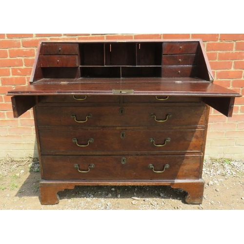 818 - A George III flame mahogany bureau with the fall front revealing a interior and two short over three... 