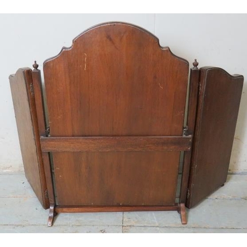 825 - An Edwardian mahogany three section folding swing vanity/table top mirror, surmounted by a walnut ve... 