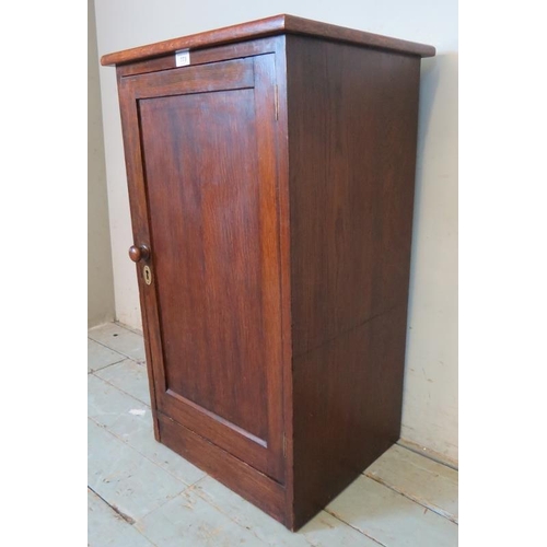 826 - An early 20th century oak pot cupboard with green vinyl insert to top and two internal fitted shelve... 