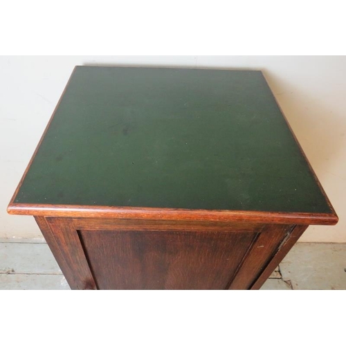 826 - An early 20th century oak pot cupboard with green vinyl insert to top and two internal fitted shelve... 