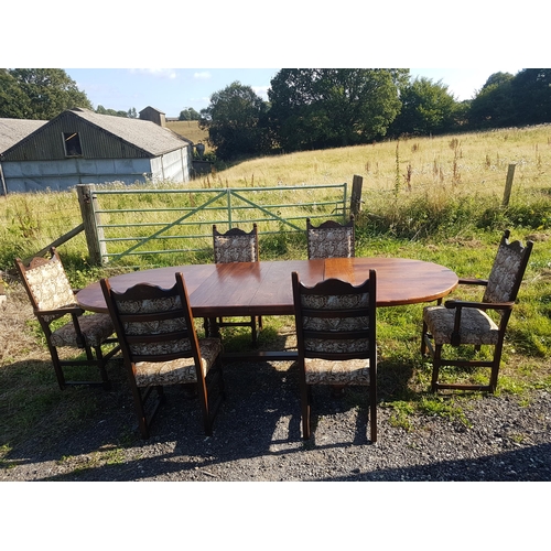 833 - A good quality reproduction extending oak dining table with two extra leaves raised on baluster supp... 