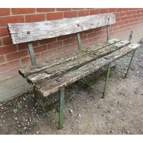 845 - An antique garden bench of heavily weathered deep grained oak mounted on three wrought iron strap wo... 