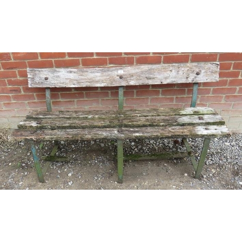 845 - An antique garden bench of heavily weathered deep grained oak mounted on three wrought iron strap wo... 