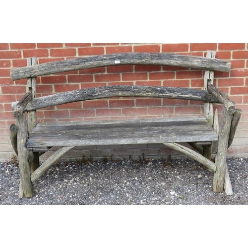 846 - A rustic nicely weathered garden bench with slatted seat and naturalistic back rest and end sections... 