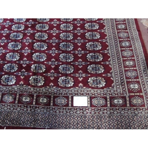 907 - A 20th century part silk Persian carpet on claret ground, slightly a/f, (72