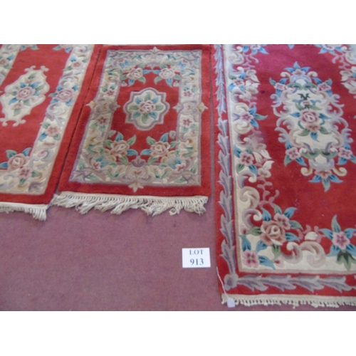 913 - A trio of Chinese rugs on red ground. 160cm x 93cm, 120cm x 63cm and 95cm x 62cm.
Estimated: £30-£50... 