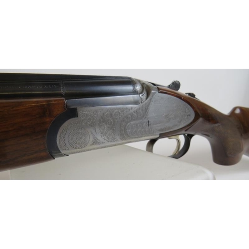 932 - A Rizzini 12 bore over-and-under multichoke, ejector, with game scene to action, 27.5