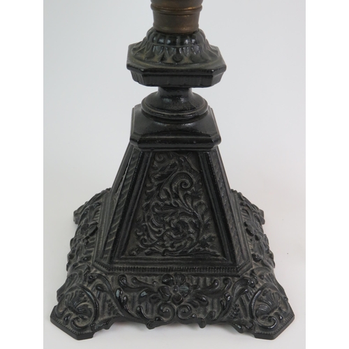 36 - A Victorian cast iron based oil lamp with hand decorated glass reservoir and spare chimney. Overall ... 