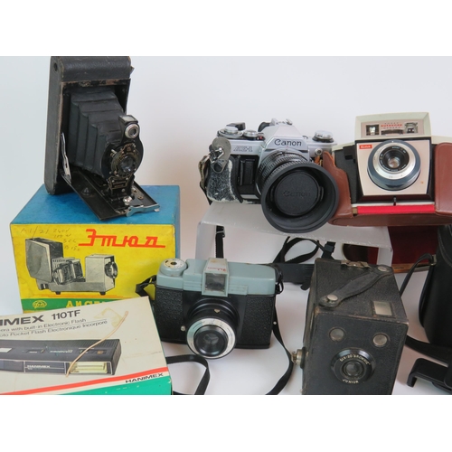 39 - A collection of vintage cameras and cases including a Canon AE1 Zorki-4, Kodak Brownies etc, plus ac... 