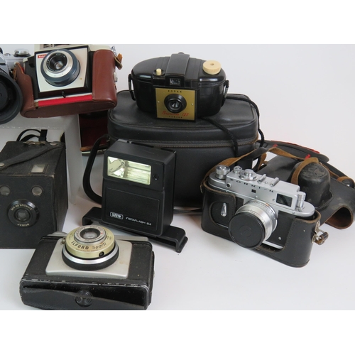 39 - A collection of vintage cameras and cases including a Canon AE1 Zorki-4, Kodak Brownies etc, plus ac... 