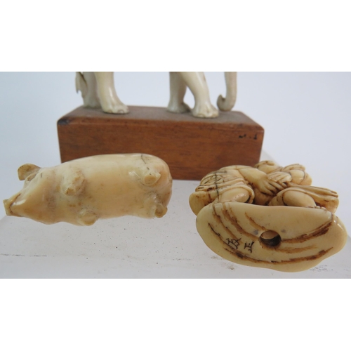 4 - A 19th Century carved ivory okimono of two wrestlers, signed to base, an antique ivory carved pig, e... 