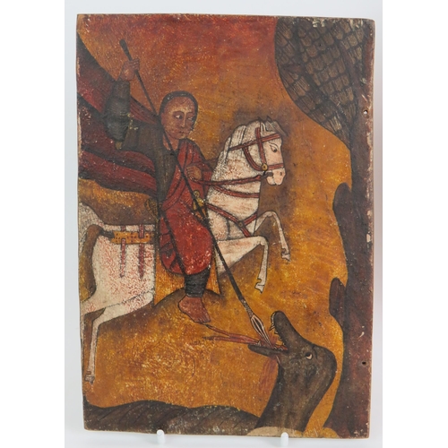 63 - A two part carved hardwood Ethiopian Christian icon depicting St George on one panel and the Madonna... 