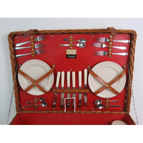 64 - A vintage Harrods Coracle whicker picnic basket fully fitted with six place settings and various con... 