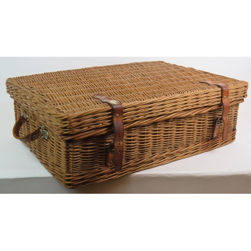 64 - A vintage Harrods Coracle whicker picnic basket fully fitted with six place settings and various con... 