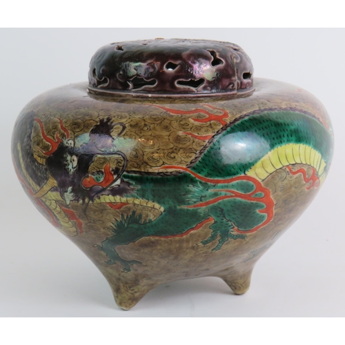 66 - A three footed Chinese porcelain covered censer jar with dragon decoration and pierced lid. Seal cha... 