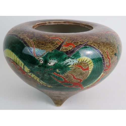 66 - A three footed Chinese porcelain covered censer jar with dragon decoration and pierced lid. Seal cha... 