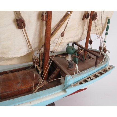 82 - A vintage scale model of a three masted schooner in full sail on separate stand. Height 92cm, length... 