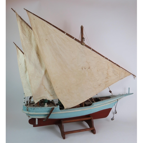 82 - A vintage scale model of a three masted schooner in full sail on separate stand. Height 92cm, length... 