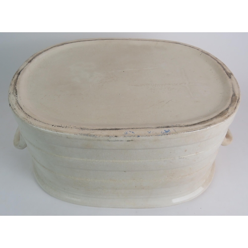 99 - A large antique glazed cream pottery footbath. 49cm x 32cm x 22cm. Condition report: Overall crazing... 