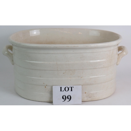 99 - A large antique glazed cream pottery footbath. 49cm x 32cm x 22cm. Condition report: Overall crazing... 