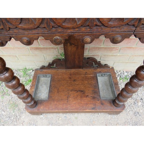 836 - A 19th century oak hall stand heavily carved with roundels & Fleur de Les in the Flemish style, with... 