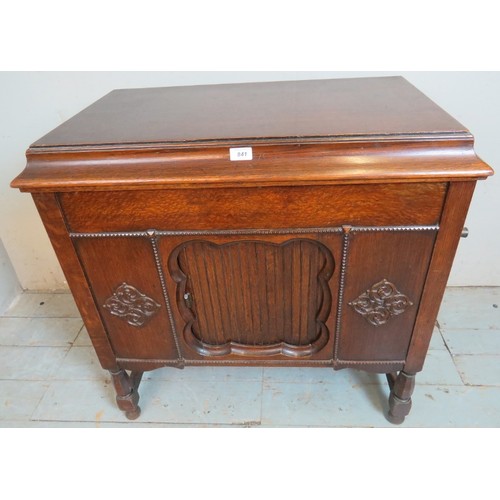 841 - A 1920's oak cased freestanding gramophone by Gilbert with applied moulded decoration to case and ta... 