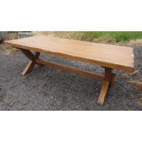 720 - A large light oak refectory style dining table with end extensions, raised on 'X' frame end supports... 