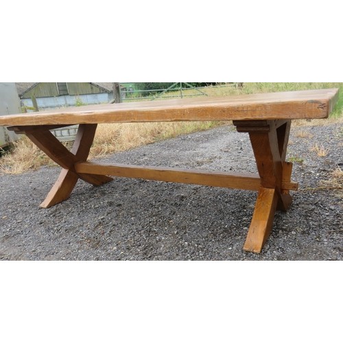 720 - A large light oak refectory style dining table with end extensions, raised on 'X' frame end supports... 