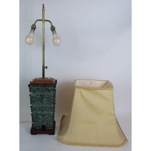 27 - A bronze based table lamp cast in the Chinese Shang Dynasty style, C1930s, with double lamp holder a... 