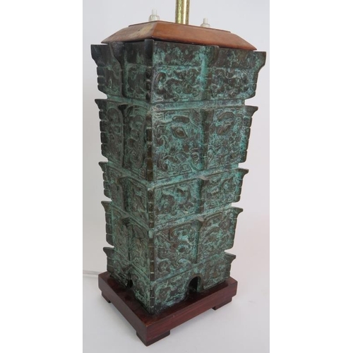 27 - A bronze based table lamp cast in the Chinese Shang Dynasty style, C1930s, with double lamp holder a... 