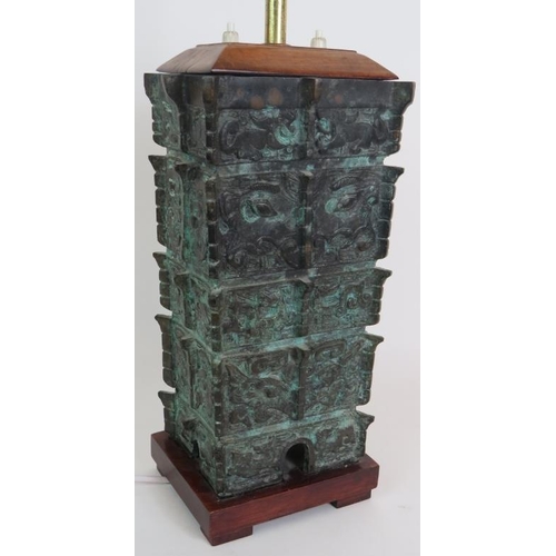 27 - A bronze based table lamp cast in the Chinese Shang Dynasty style, C1930s, with double lamp holder a... 