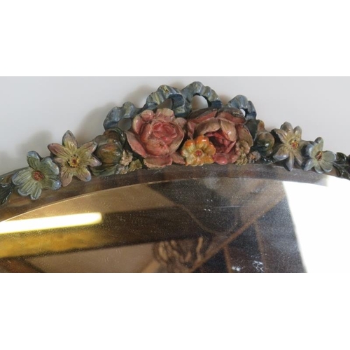 54 - An oval early 20th Century Barbola mirror with floral  moulding and bevelled glass. Width 60cm. Heig... 