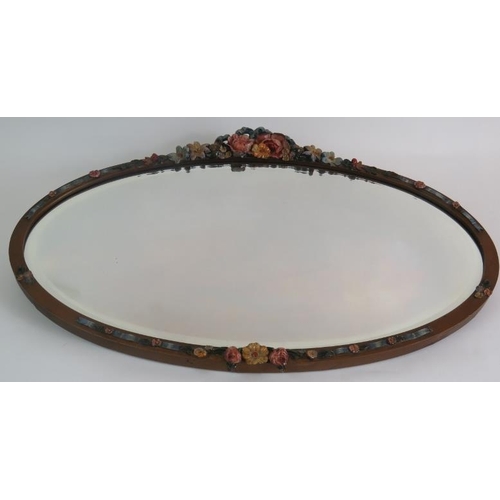 54 - An oval early 20th Century Barbola mirror with floral  moulding and bevelled glass. Width 60cm. Heig... 