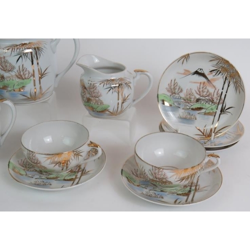 63 - A mid 20th Century  Japanese Kutani part tea set comprising 16 pieces including two Geisha lithophan... 