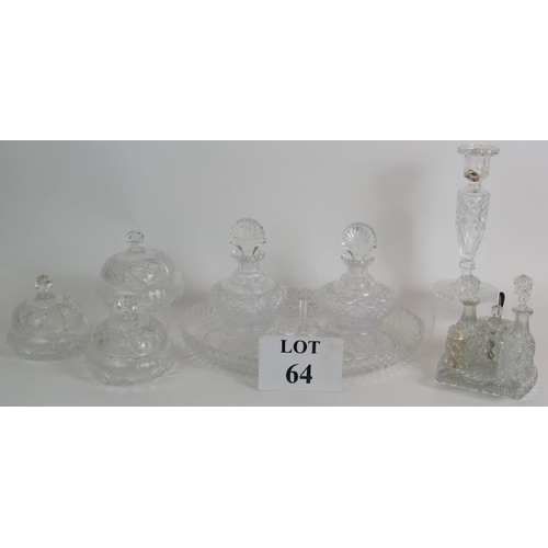 64 - A four piece cut crystal dressing table set, three similar covered jars, a cut glass candlestick and... 
