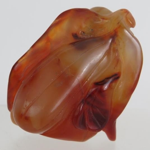 67 - A Chinese carved hardstone snuff bottle of melon and leaf form, probably russet Jade. No spoon. Heig... 