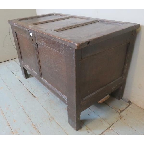 707 - An 18th century oak coffer of small proportions carved with the initials 'T'S', raised on style feet... 