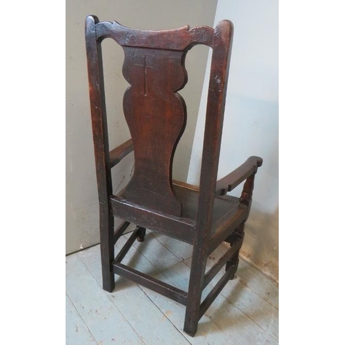 729 - An early 18th century oak carver hall chair of excellent colour and patina.
114cm high x 60cm wide x... 